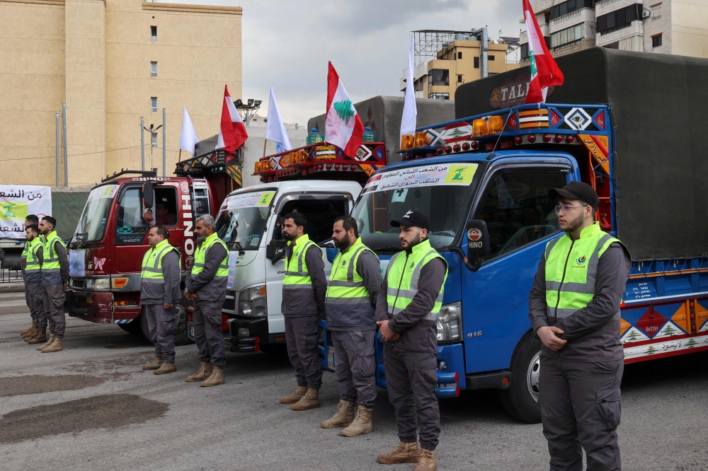 Trucks loaded with humanitarian aid provided by Lebanese Shiite group Hezbollah set out for Syria from the Lebanese capital's southern suburb on February 12, 2023, in the aftermath of a deadly earthquake. (Photo by ANWAR AMRO / AFP)