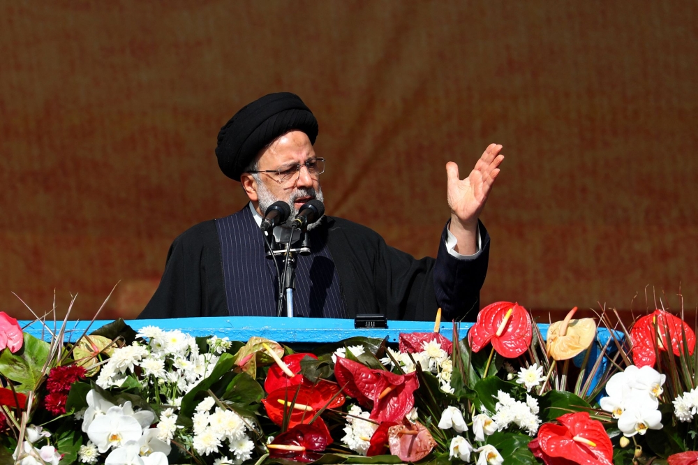 A handout picture provided by the Iranian presidency shows President Ibrahim Raisi addressing the crowds gathered in Tehran's Azadi Square to mark the 44nd anniversary of the 1979 Islamic Revolution, on February 11, 2023. (Photo by Iranian Presidency / AFP) 