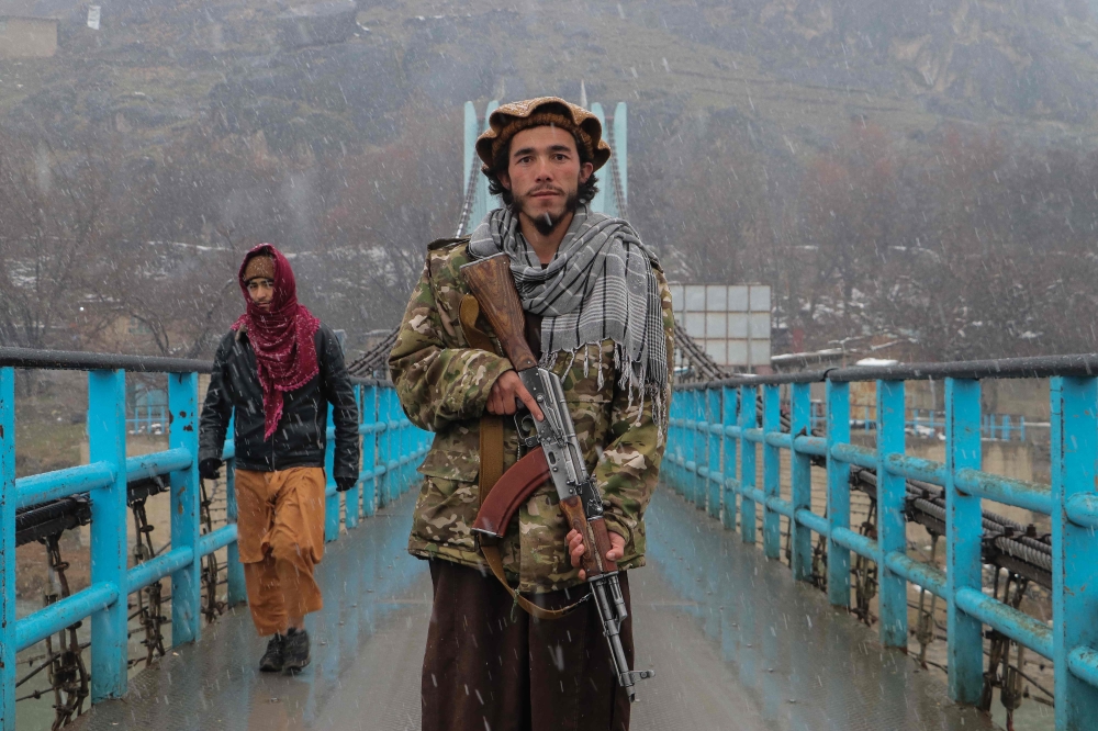 A Taliban security personnel poses for a photo along a bridge in Fayzabad district of Badakhshan province on February 13, 2023. (Photo by OMER ABRAR / AFP)