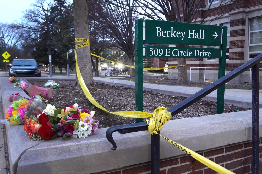 Flowers and crime scene tape are shown outside Berkey Hall on the campus of Michigan State University on February 14, 2023 in East Lansing, Michigan. 