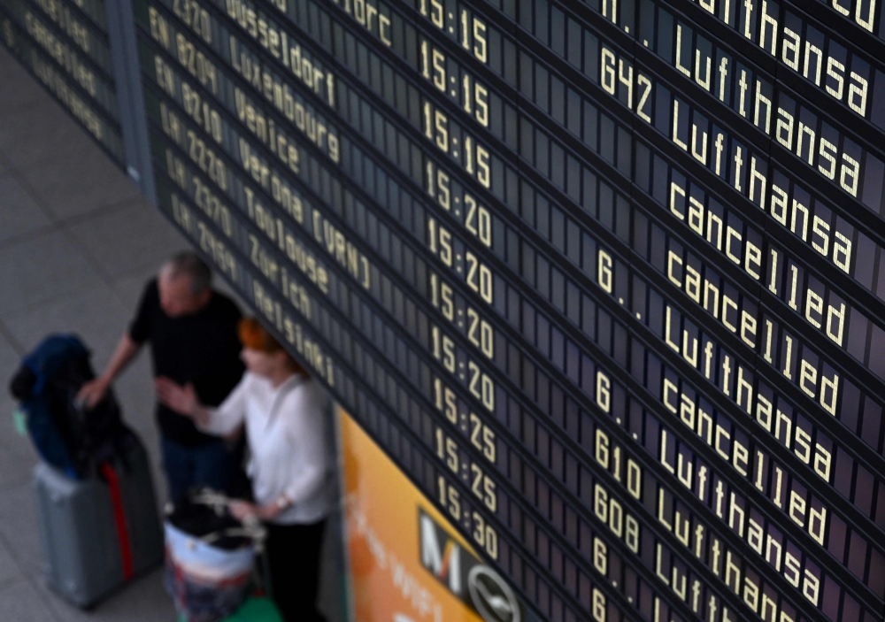 In this file photo taken on September 2, 2022 a display announces cancelled flights in the Lufthansa terminal of the Franz-Josef-Strauss airport in Munich, southern Germany, as pilots called for a strike affecting the Lufthansa passenger airline and Lufthansa Cargo after pay negotiations with the German airline collapsed. Photo by Christof STACHE / AFP