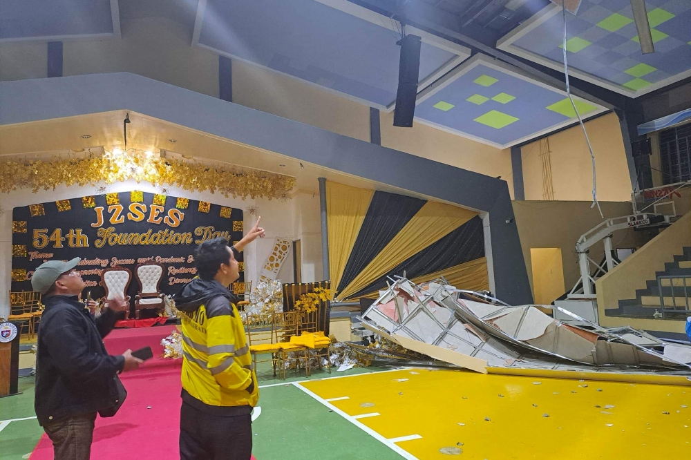 This handout photo received from the City of Masbate Disaster Risk Reduction Management Office on February 16, 2023 shows officials assessing the damage at Magallanes Coliseum in Masbate, after a 6.1-magnitude earthquake rocked the central Philippines. (Photo by Handout / City of Masbate Disaster Risk Reduction Management Office / AFP)