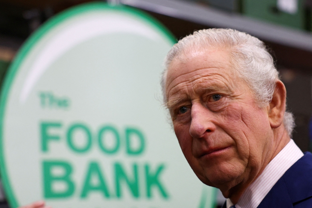 Britain's King Charles III visits the Milton Keynes food bank in Milton Keynes, north of London on February 16, 2023, to see the support they provide to communities across the city. (Photo by Molly Darlington / AFP)