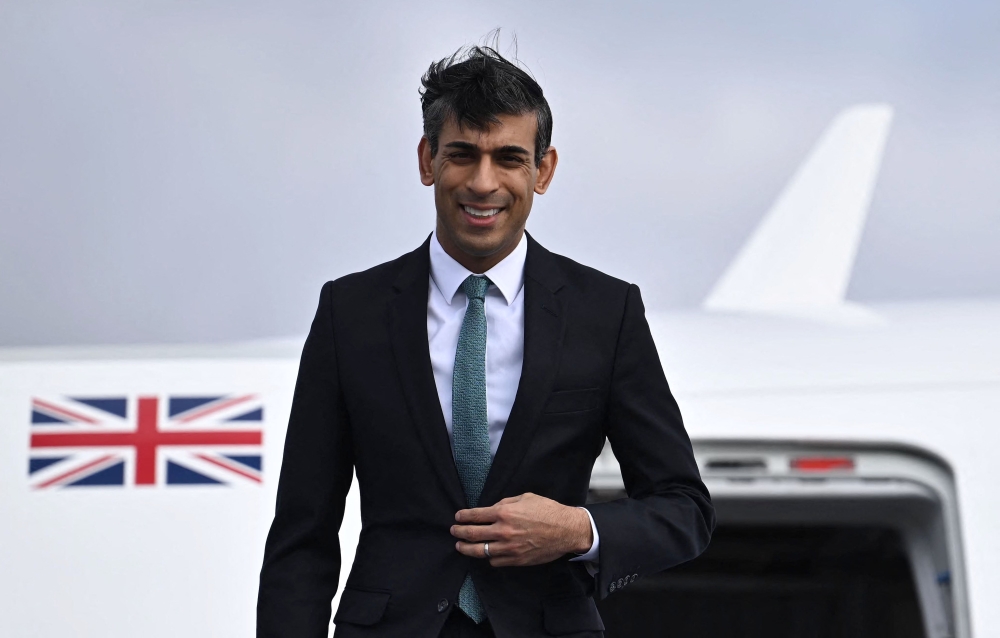 Britain's Prime Minister Rishi Sunak gets off his plane after his arrival on February 18, 2023 at the airport in Munich, southern Germany, where he will attend the Munich Security Conference (MSC). (Photo by Ben Stansall / POOL / AFP)