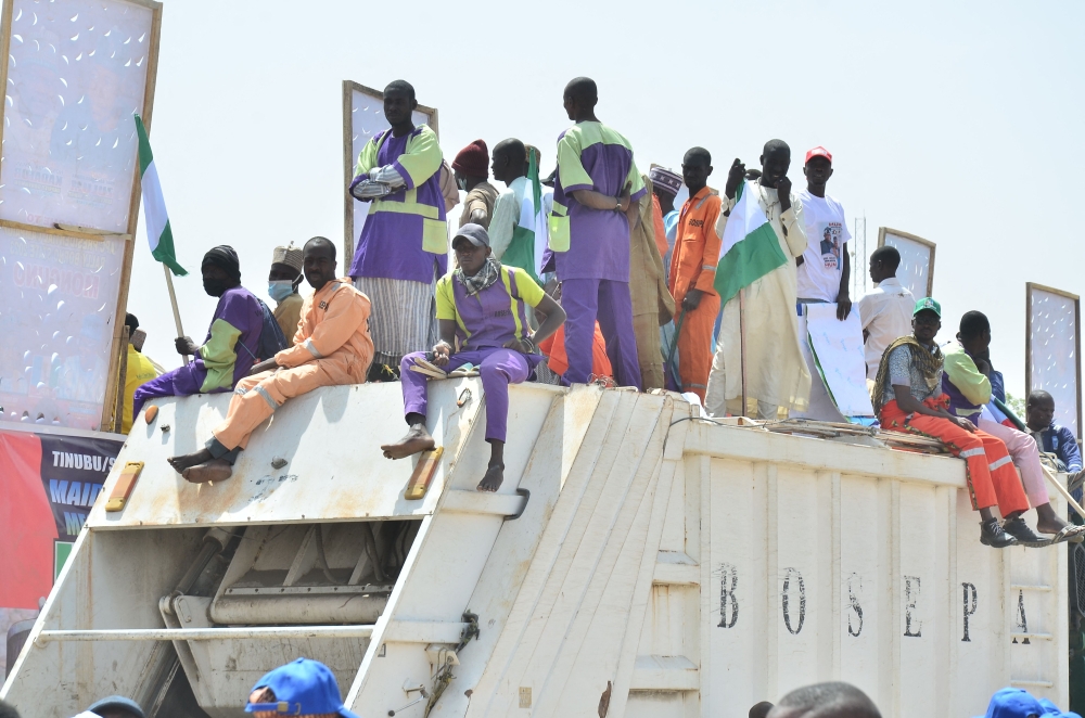 Supporters sit on a truck during an All progressives Congress (APC) rally in Maiduguri on February 18, 2023 ahead of the Nigerian presidential elections scheduled for February 25, 2023. (Photo by Audu MARTE / AFP)