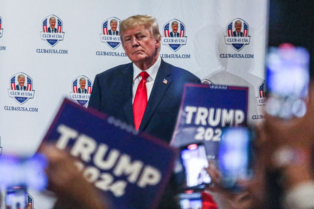 Former US President Donald Trump gestures to supporters during Trump's President Day event at the Hilton Palm Beach Airport in West Palm Beach, Florida, on February 20, 2023. (Photo by GIORGIO VIERA / AFP)