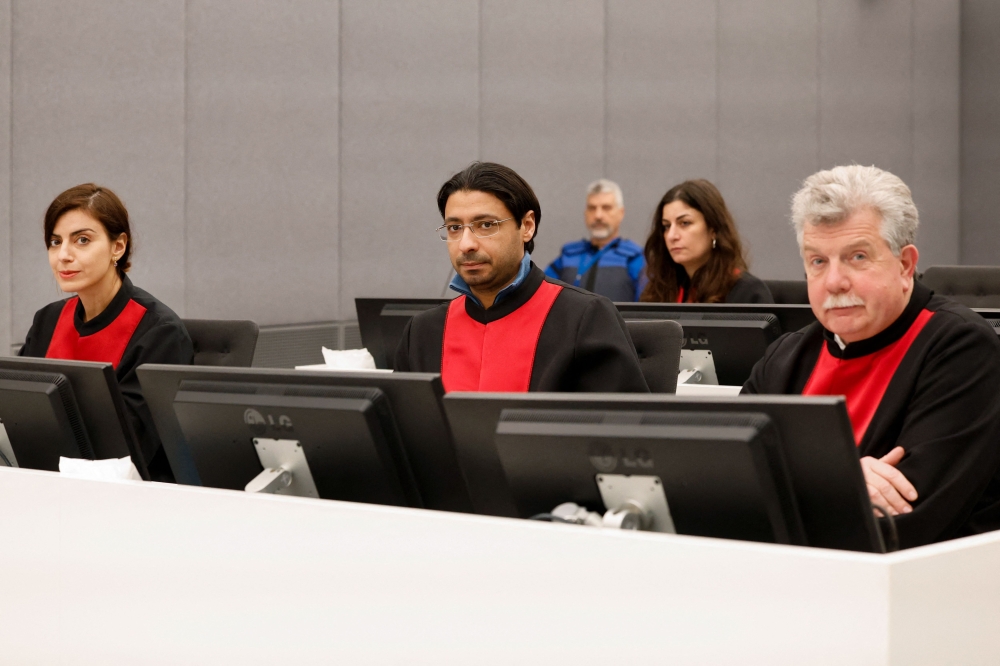 Lawyers Jean-Louis Gilissen (R), Leto Cariolou (L) and Hedi Aouini (C) attend the start of the trial of former Kosovo Liberation Army (KLA) member, Pjeter Shala, also known as 