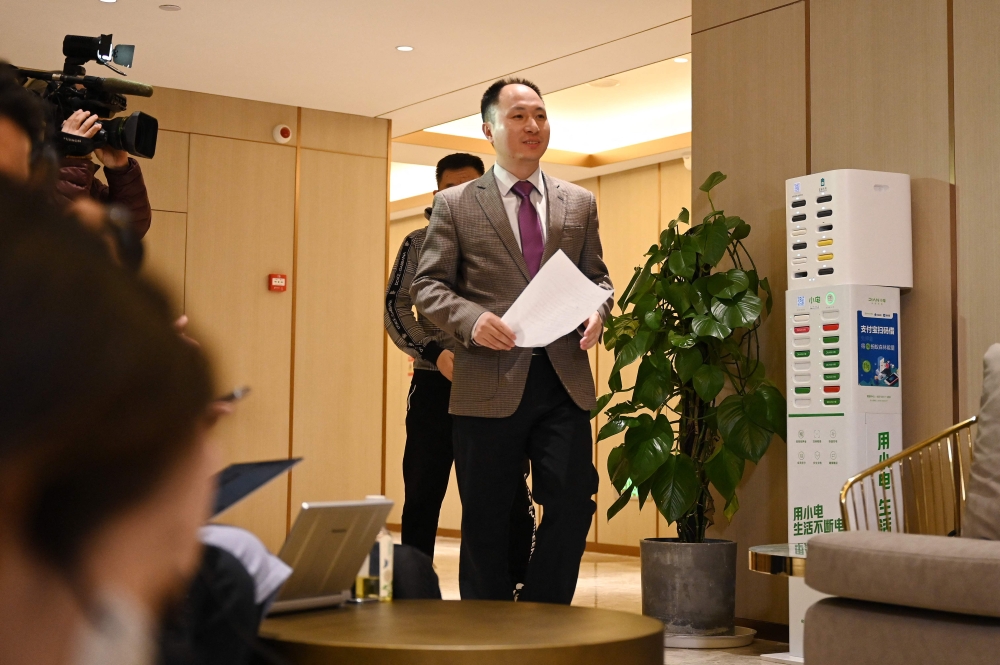 Chinese scientist He Jiankui arrives before reading a statement to the media at a hotel in Beijing on February 21, 2023.  (Photo by GREG BAKER / AFP)