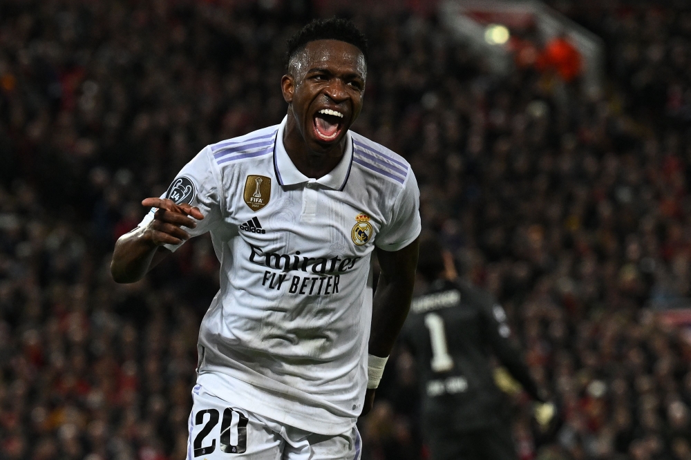 Real Madrid's Brazilian Vinicius Junior celebrates scoring the team's second goal during the UEFA Champions League last 16 first leg match between Liverpool and Real Madrid at Anfield in Liverpool, north west England on February 21, 2023. (Photo by Paul ELLIS / AFP)