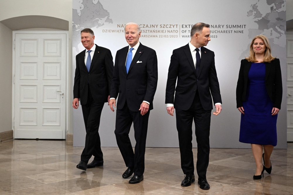 US President Joe Biden  together with the Polish President Andrzej Duda (second right), Romanian President Klaus Iohannis (left) and Slovakian President Zuzana Caputova attend a Bucharest Nine (B9) meeting at the Presidential Palace in Warsaw on February 22, 2023. (Photo by Mandel NGAN / AFP)