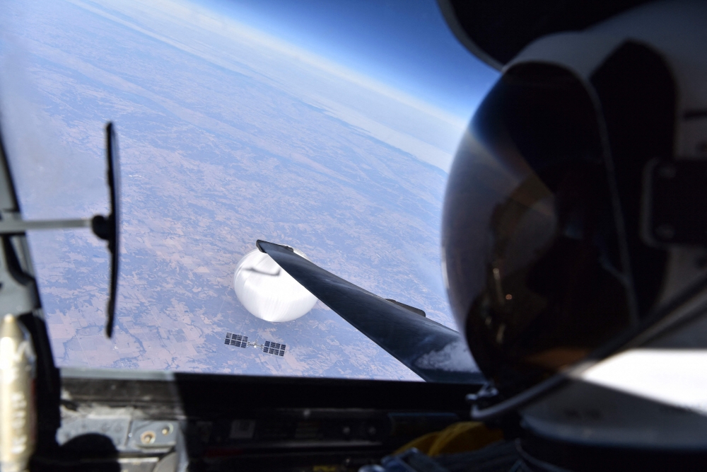 In this handout photo provided by the US Department of Defense on February 22, 2023, a US Air Force pilot looks down at the suspected Chinese surveillance balloon as it hovers over the Central Continental United States on February 3, 2023. Photo by US Department of Defense / AFP
