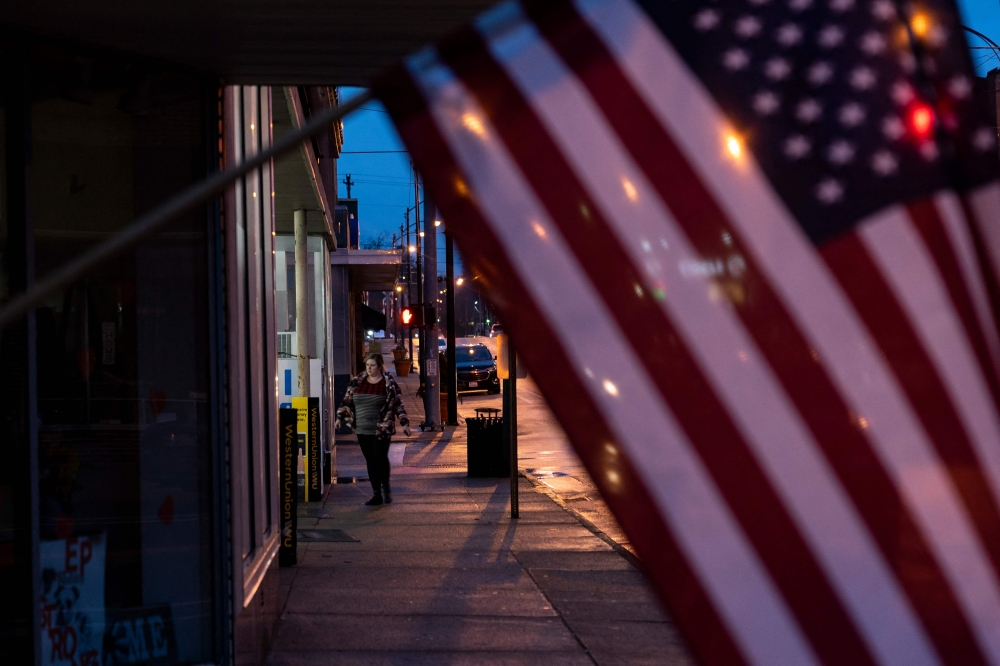 EAST PALESTINE, OH - FEBRUARY 22: A resident of East Palestine, Ohio walks down East Market Street on February 22, 2023. On February 3, a Norfolk Southern train derailed, causing 38 cars of about 150 to fall off the tracks and cars carrying hazardous materials to catch fire. Three days later, the railroad burned vinyl chloride from five tanker cars to prevent an explosion, according to published reports. At least 1,500 were ultimately forced to evacuate. Michael Swensen/Getty Images/AFP.