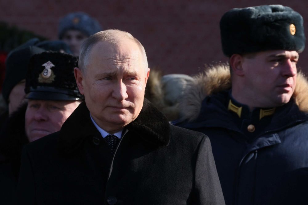 Russian President Vladimir Putin attends a wreath-laying ceremony at the Eternal Flame and the Unknown Soldier's Grave in the Alexander Garden during an event marking Defender of the Fatherland Day in Moscow on February 23, 2023. (Photo by Mikhail Metzel / AFP)