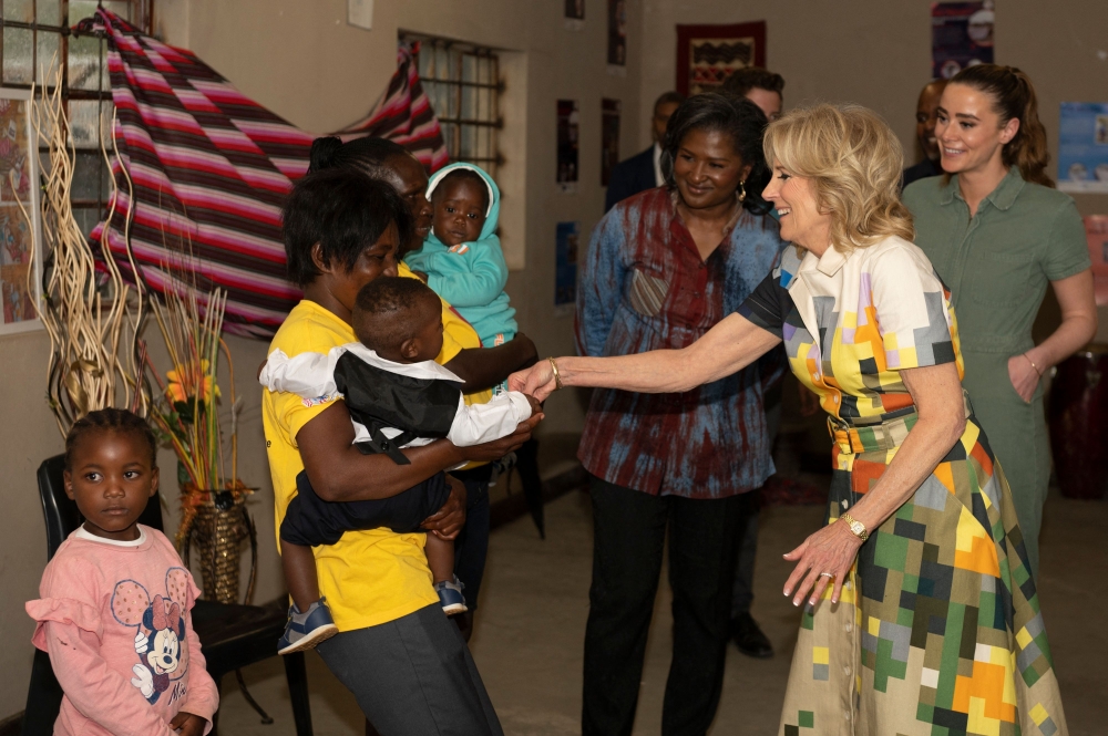 US First Lady Jill Biden and Namibia's First Lady Monica Geingos (3rd right) meet two mothers, Linea and Monica, and their children that are beneficiaries of Development Aid from People to People (DAPP), at the Hope Initiative Southern Africa in Windhoek on February 23, 2023. (Photo by Tara Mette / AFP)