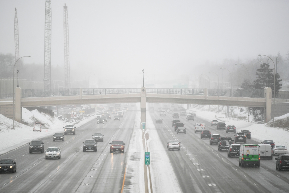 Traffic is moving on interstate 35W during a snowstorm in Minneapolis, Minnesota, on February 22, 2023. Photo by Craig LASSIG / AFP