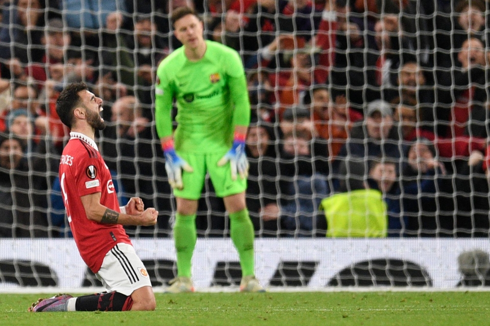 Manchester United's Portuguese midfielder Bruno Fernandes celebrates at the end of the UEFA Europa league knockout round play-off second leg football match between Manchester United and FC Barcelona at Old Trafford stadium in Manchester, north west England, on February 23, 2023. - Manchester United won 2 - 1 against FC Barcelona. (Photo by Oli SCARFF / AFP)