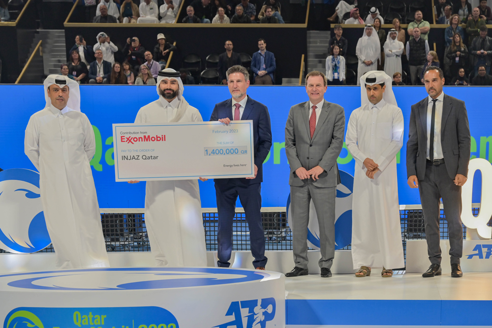 Dominic Genetti, President and General Manager of ExxonMobil Qatar, presentes the donation to Emad Al Khaja, Chief Executive Officer of INJAZ Qatar, in the presence of H E Nasser bin Ghanim Al Khelaifi, President of Qatar Tennis Federation, and Neil Chapman, Senior Vice President of Exxon Mobil Corporation.