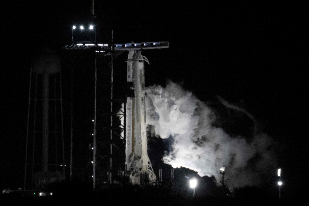 The SpaceX Falcon 9 rocket with the company Crew Dragon spacecraft vents fuel prior to a scrubbed launch from pad 39A for the Crew-6 mission at NASA's Kennedy Space Center in Cape Canaveral, Florida, on February 27, 2023. (Photo by Jim WATSON / AFP)