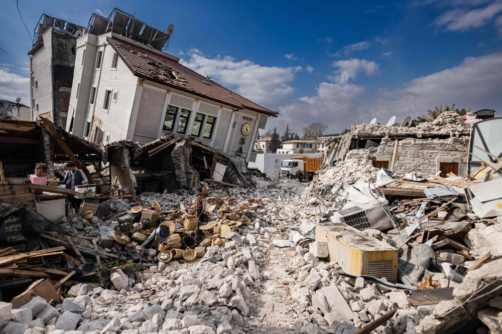 This photograph shows collapsed buildings in the city of Antakya on February 19, 2023. (Photo by Sameer Al-Doumy / AFP)

