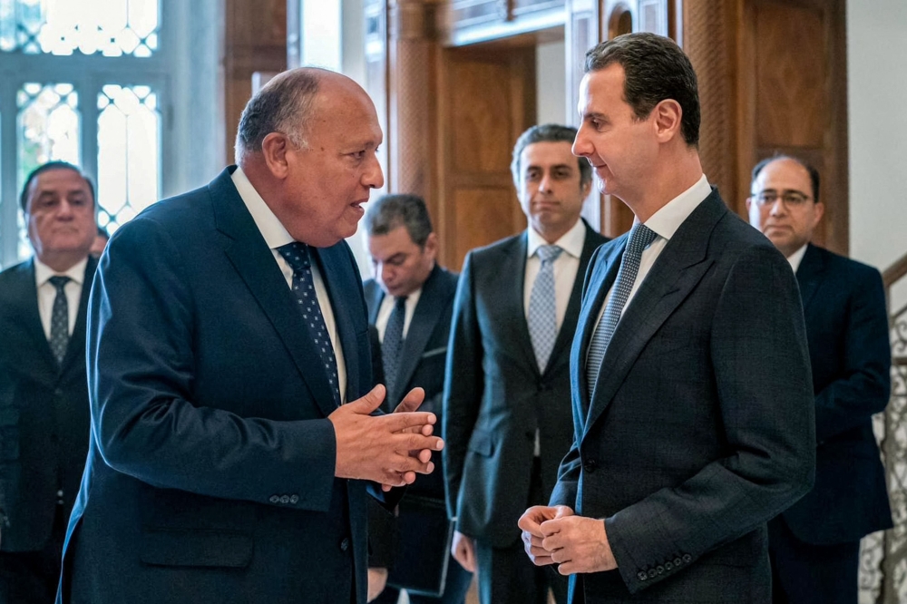 This handout picture released by the Egyptian Foreign Ministry shows Egypt's Foreign Minister Sameh Shoukry (left) meeting with Syrian President Bashar al-Assad in Damascus on February 27, 2023.  (Photo by AFP)