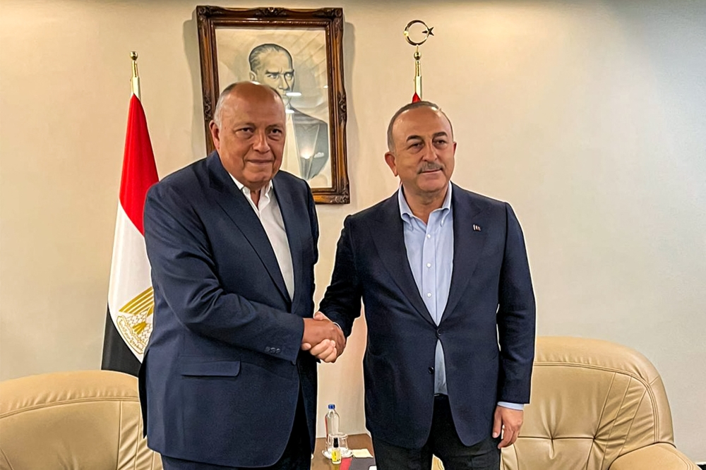 This handout picture released by the Egyptian Foreign Ministry shows Egypt's Foreign Minister Sameh Shoukri (left) meeting with his Turkish counterpart Mevlut Cavusoglu in Adana in central southern Turkiye on February 27, 2023. (Photo by Egyptian Foreign Ministry Spokesperson / AFP) 