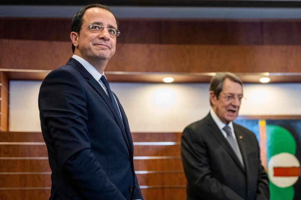 Cyprus' President-elect Nikos Christodoulides (L) attends a meeting with outgoing-President Nicos Anastasiades before his investiture ceremony at the parliament in Nicosia on February 28, 2023. (Photo by Jewel SAMAD / AFP)