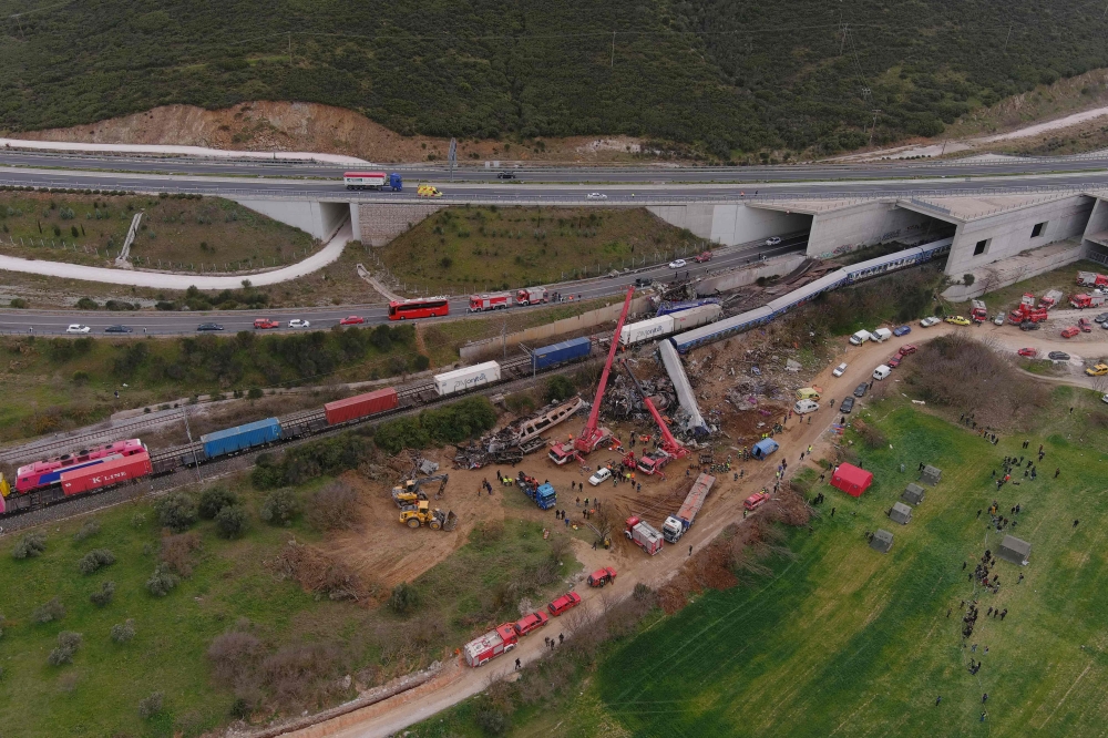 This aerial drone photograph taken on March 1, 2023, shows emergency crews examining the wreckage after a train accident in the Tempi Valley near Larissa, Greece. (AFP)