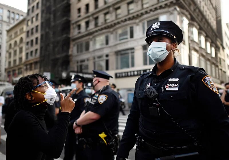 Shouting protesters face NYPD officers during a Black Lives Matter demonstration last summer in New York City, in outrage over the death of a Black man in Minnesota who died after a white policeman knelt on his neck for several minutes. File photo / AFP
