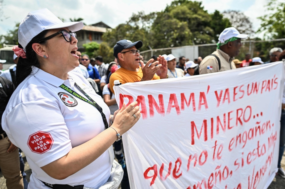 Workers of Canadian First Quantum Minerals mining company hold a protest in front of the Marine Authority of Panama, in Panama City on March 1, 2023, following the company announcement -last February 23- of the suspension of operations at a major mine on the grounds that it was being blocked from exporting copper abroad. (Photo by Luis ACOSTA / AFP)

