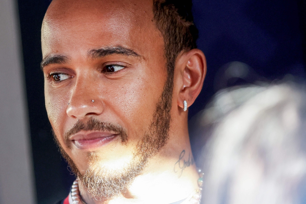 Mercedes' British driver Lewis Hamilton arrives in the paddock at the Bahrain International Circuit in Sakhir ahead of the Bahrain Formula One Grand Prix on March 2, 2023. (Photo by Giuseppe CACACE / AFP)

