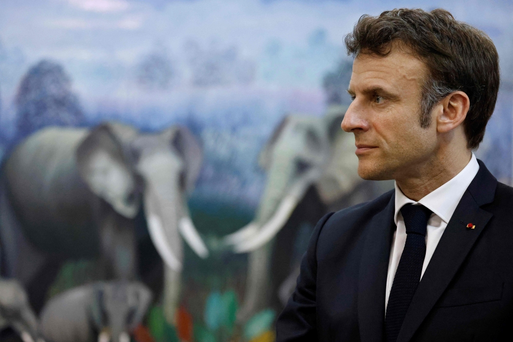 France's President Emmanuel Macron looks on as he meets with congolese artists at the French Institue in Luanda on March 4, 2023. - The French President is in Kinshasa on the fourth and last leg of an African tour. (Photo by LUDOVIC MARIN / POOL / AFP)