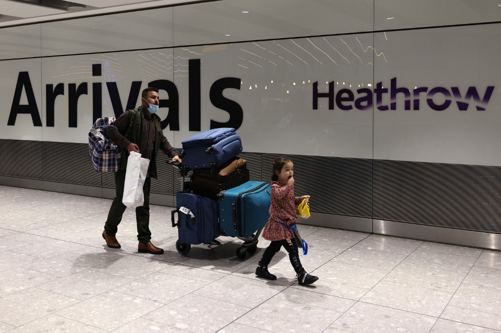 In this file photo taken on November 30, 2021 people arrive at Heathrow's Terminal 5 in west London. (AFP/Adrian Dennis)