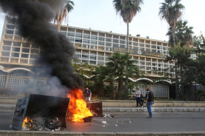 Lebanese demonstrators block a road with burning tyres in front of the Electricite Du Liban company building in the southern city of Sidon, as the country struggles with a deep economic crisis. File photo / AFP 