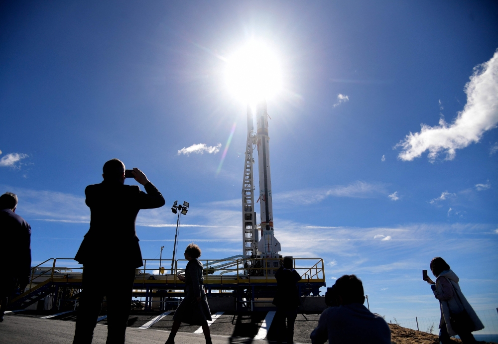 Jounalists gather next to the Spanish aerospace company PLD Space's 'Miura-1' suborbital rocket, the first European private rocket to be launched into space, in Almonte's launch pad, near Huelva, southern Spain, on March 11, 2023. - 'Miura-1' micro rocket is aimed at sending small satellites to space. (Photo by CRISTINA QUICLER / AFP)