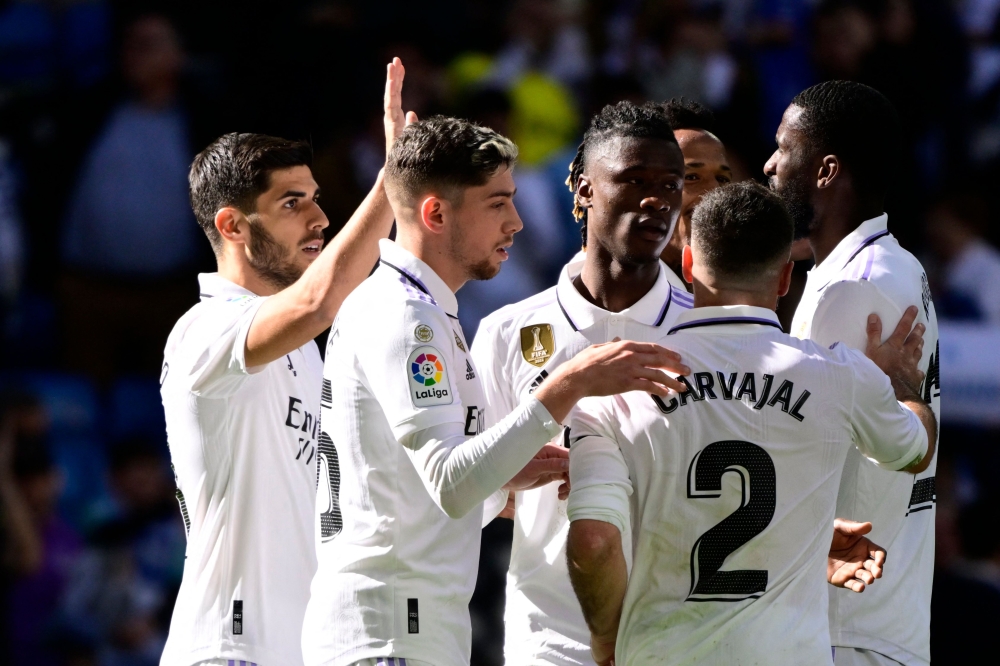 Real Madrid's Spanish midfielder Marco Asensio (left) celebrates with teammates scoring his team's third goal during the Spanish league football match between Real Madrid CF and RCD Espanyol at the Santiago Bernabeu stadium in Madrid on March 11, 2023. (Photo by JAVIER SORIANO / AFP)
