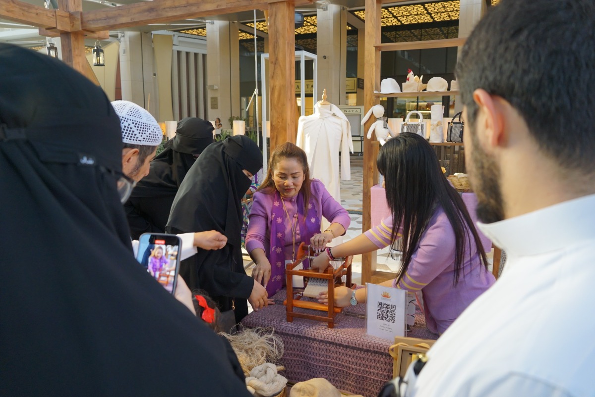 Visitors are intrigued by the craftmanship of making Bua Luang banana fabric during the Earthna Summit 2023 in Doha.
