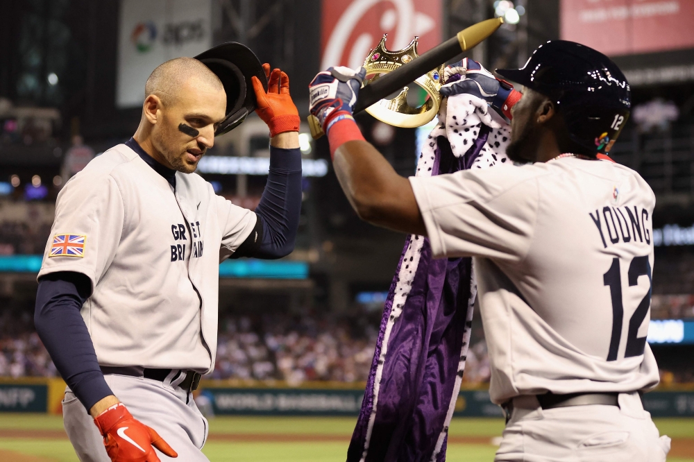 Trayce Thompson #43 of Team Great Britain is congratulated by Chavez Young #12 after hitting a solo home run against Team USA during the first inning of the World Baseball Classic Pool C game at Chase Field on March 11, 2023 in Phoenix, Arizona. Christian Petersen/Getty Images/AFP (Photo by Christian Petersen / GETTY IMAGES NORTH AMERICA / Getty Images via AFP)