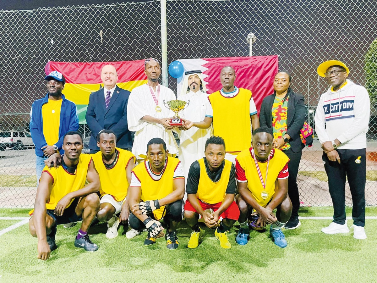 Ghana Ambassador to Qatar H E Mohamed Nurudeen Ismaila, Walking Football Federation President Farhan Al Sheikh Al Sayed and LuLu International Regional Operations Manager Simon Alexander with the Ugandan team, winners of the tournament.