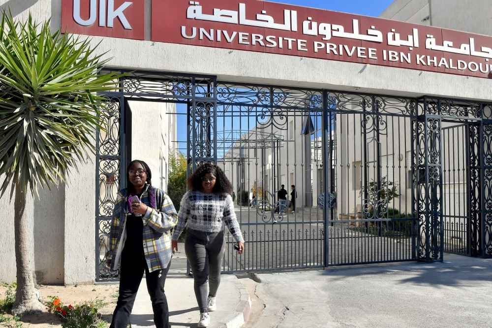African students walk at the campus of university Ibn Khaldoun, on March 13, 2023 in Tunis. - Thousands of sub-Saharan African students in Tunisia are seeking safety assurances from authorities in the aftermath of a spate of racist attacks, which followed comments by President Kais Saied about illegal migration. (Photo by FETHI BELAID / AFP)