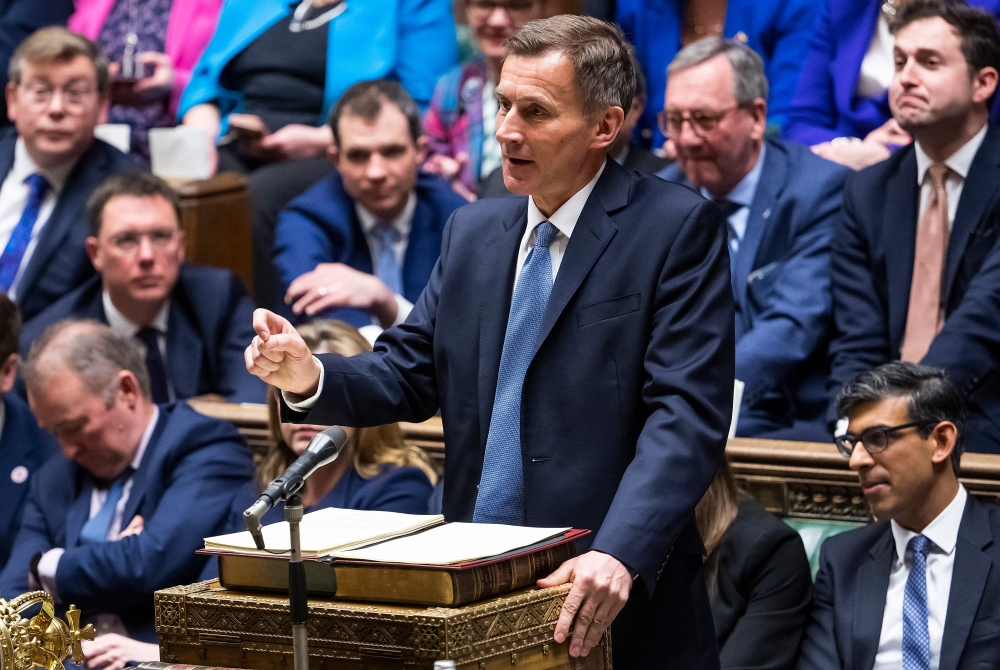 A handout photograph released by the UK Parliament shows Britain's Chancellor of the Exchequer Jeremy Hunt standing at the despatch box making his annual budget statement in the House of Commons in London on March 15, 2023.  (Photo by Andy Bailey / UK PARLIAMENT / AFP)