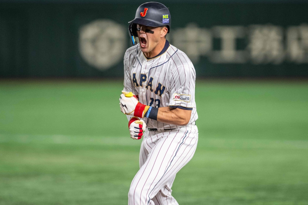 Japan's Lars Nootbaar reacts after hitting a single during the World Baseball Classic (WBC) quarter-final game between Japan and Italy at the Tokyo Dome in Tokyo on March 16, 2023. (Photo by Yuichi YAMAZAKI / AFP)