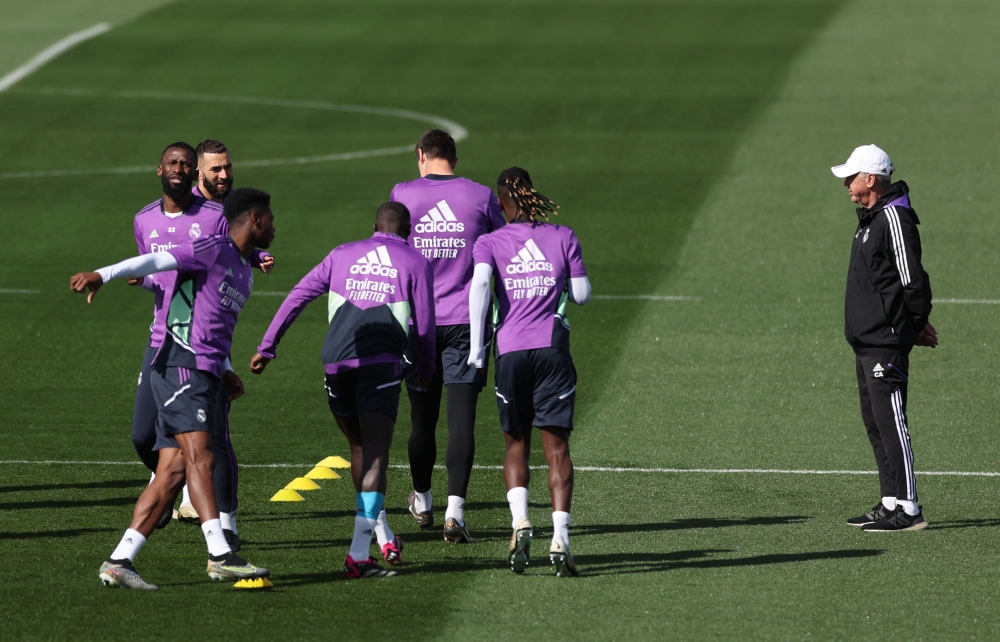 Real Madrid's Italian coach Carlo Ancelotti (right) looks on as Real Madrid's players attend a training session at the Ciudad Real Madrid training complex in Valdebebas, outskirts of Madrid, on March 18, 2023, on the eve of the Spanish league 'El Clasico' football match between Barcelona and Real Madrid. (Photo by PIERRE-PHILIPPE MARCOU / AFP)