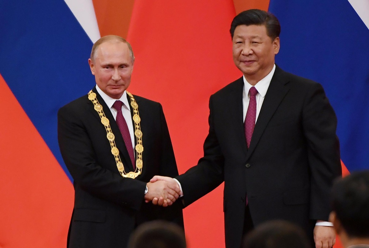 File Photo: Chinese President Xi Jinping congratulates Russian President Vladimir Putin after presenting him with the Friendship Medal in the Great Hall of the People in Beijing, China, June 8, 2018. (REUTERS)