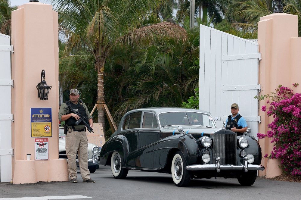 A security person stands at an entrance to former President Donald Trump's Mar-a-Lago home on March 19, 2023 in Palm Beach, Florida. Joe Raedle/Getty Images/AFP