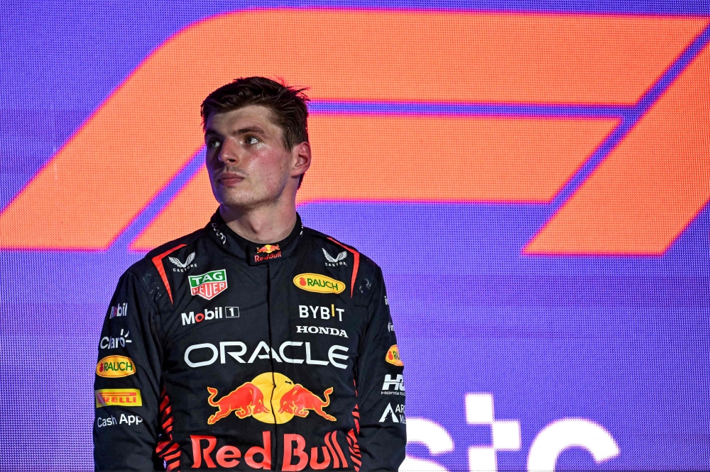 Red Bull Racing's Dutch driver Max Verstappen reacts on the podium after placing second at the end of the Saudi Arabia Formula One Grand Prix at the Jeddah Corniche Circuit in Jeddah on March 19, 2023. Photo by Ben Stansall / AFP