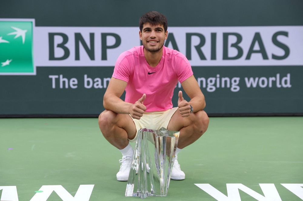 Carlos Alcaraz of Spain with the winners trophy after defeating Daniil Medvedev in the final during the BNP Paribas Open on March 19, 2023 in Indian Wells, California. Julian Finney/Getty Images/AFP