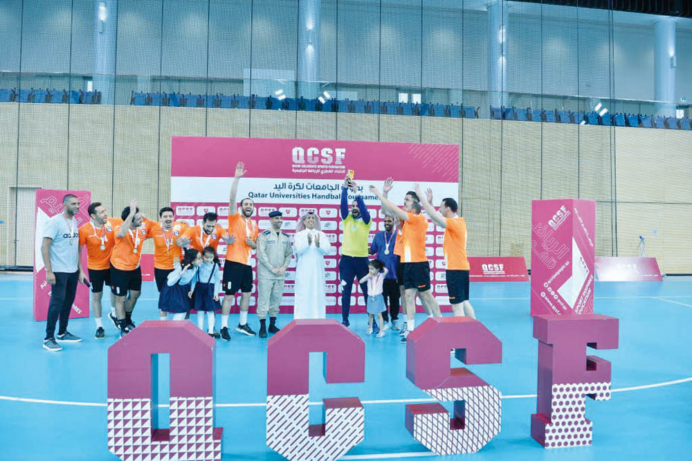 Qatar Collegiate Sports Federation President Dr. Ibrahim bin Saleh Al Naimi with Qatar Universities Handball League champions Police Institute players and officials.