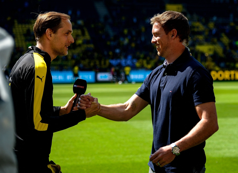 (FILES) This file photo taken on May 6, 2017 shows then Dortmund's head coach Thomas Tuchel (L) and then Hoffenheim's head coach Julian Nagelsmann shaking hands prior to the German first division Bundesliga football match between Borussia Dortmund and TSG 1899 Hoffenheim in Dortmund, western Germany. 