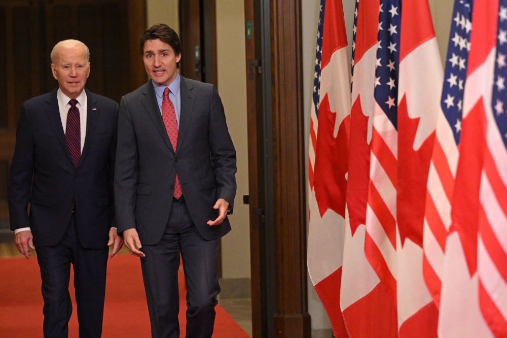 Canada's Prime Minister Justin Trudeau (right) walks with US President Joe Biden after welcoming him at Parliament Hill in Ottawa, Canada, on March 24, 2023. (Photo by Mandel Ngan / AFP)