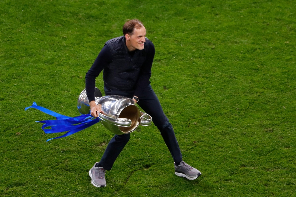 (FILES) In this file photo taken on May 29, 2021 Chelsea's German coach Thomas Tuchel celebrates with the trophy after winning the UEFA Champions League final football match at the Dragao stadium in Porto.